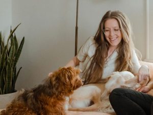 Twee jonge vrouwen met honden op de bank